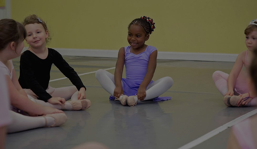 little girls dance class doing criss-cross applesauce